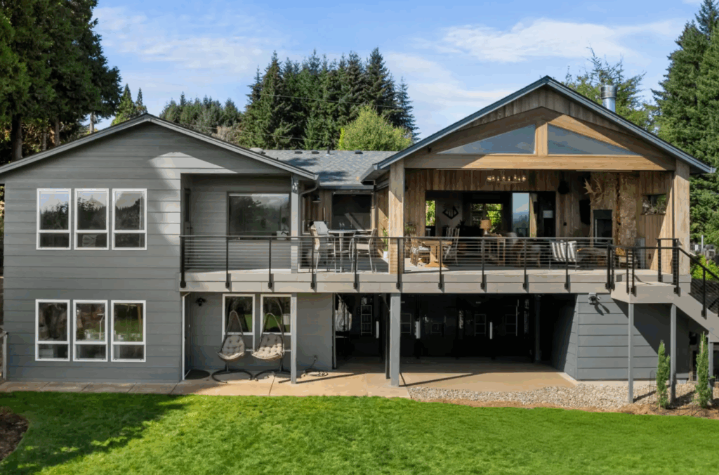 The exterior of a beautiful two-story home remodel with dark siding and enhanced outdoor space