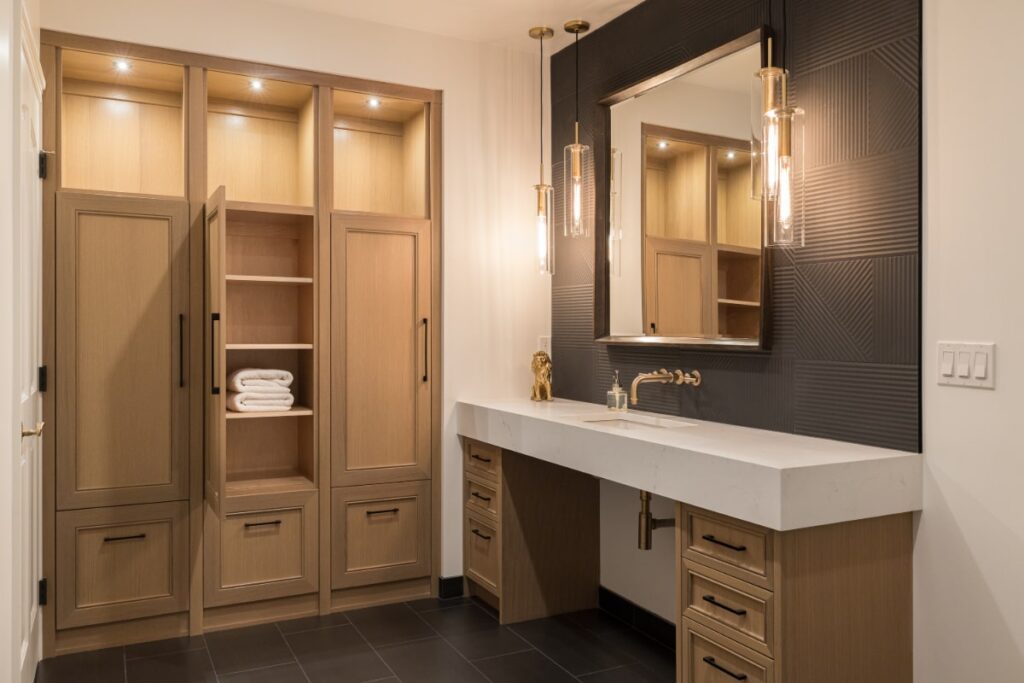 Buell 2020 new bathroom with single vanity and sink to the right and lots of storage to the left to help illustrate how to Survive a Bathroom Remodel.